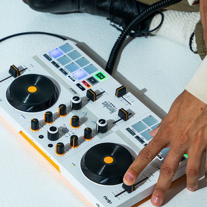 Angled front view of Hercules DJControl Mix Ultra DJ Controller being used by DJ on white surface