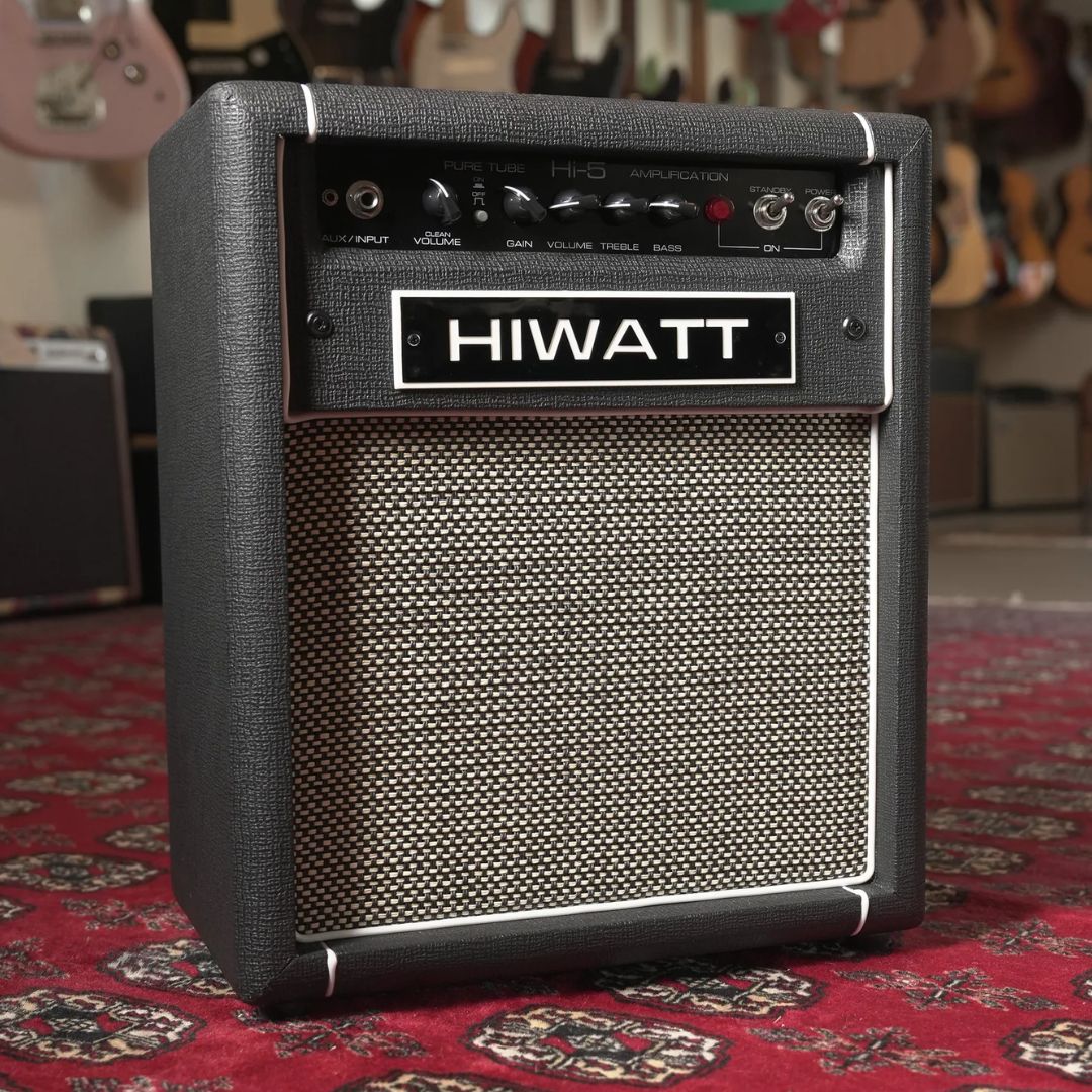Angled front view of Hiwatt Hi-5 Combo Guitar Amplifier on red carpet with guitars in the background
