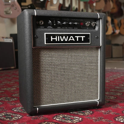 Angled front view of Hiwatt Hi-5 Combo Guitar Amplifier on red carpet with guitars in the background