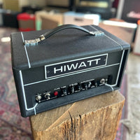 Angled front view of Hiwatt Hi-5 Guitar Amplifier Head on log table in studio