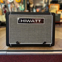 Front view of Hiwatt LEEDS AC60 Combo Guitar Amplifier on wooden surface with guitars in the background