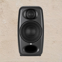 Black speaker on a beige textured background