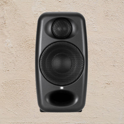 Black speaker on a beige textured background