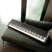 Top view of Korg B2+ Black on couch in living room