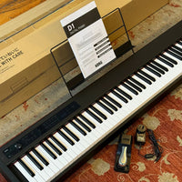 Angled top view of Korg D1 Digital Piano on red carpet