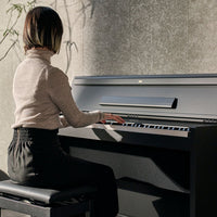 Front view of Korg E1 Air Digital Piano with person playing it in living room