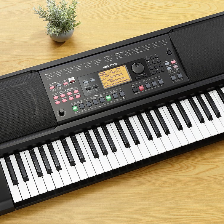 Angled top view of Korg EK-50 on wooden surface