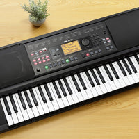 Angled top view of Korg EK-50 on wooden surface