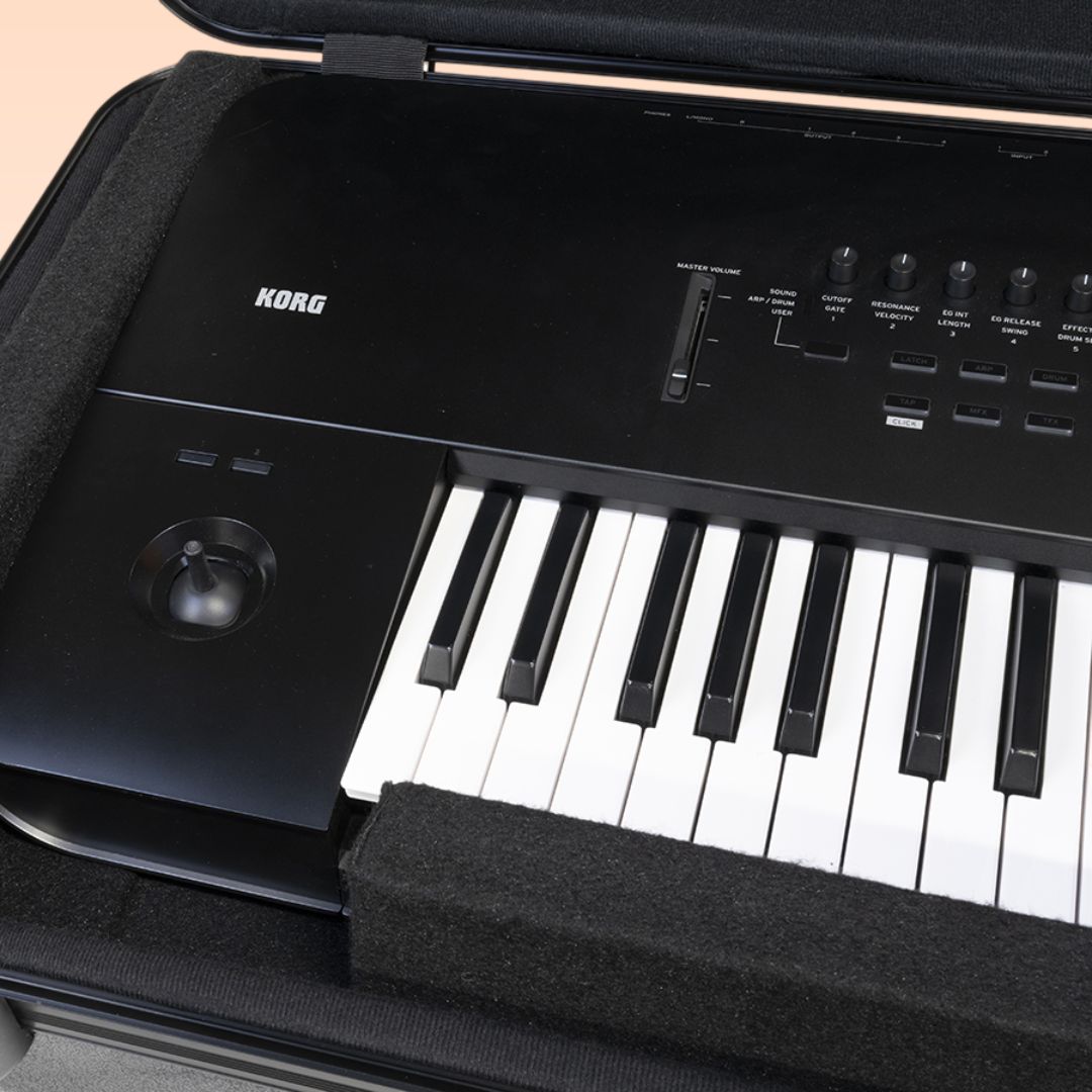 Close up view of Korg HC-88 open lid with keyboard in it on peach background