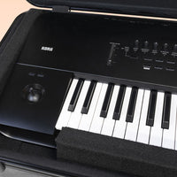 Close up view of Korg HC-88 open lid with keyboard in it on peach background