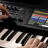Close up view of hands playing the Korg KRONOS Music Workstation