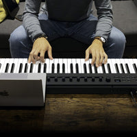 Korg Keystage Poly AT MIDI Keyboard 61 Keys being played on wooden surface with laptop beside it