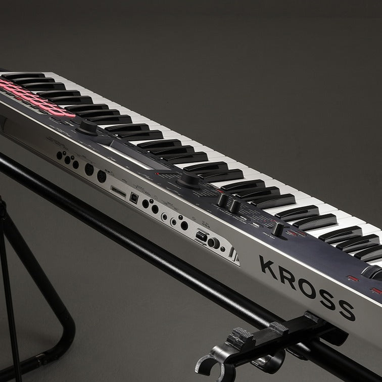 Angled view of Korg Kross 2 on stand with grey background