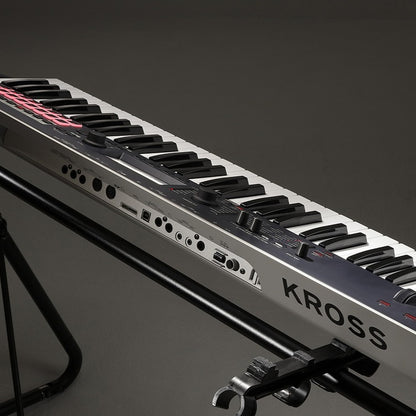 Angled view of Korg Kross 2 on stand with grey background