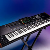 Angled front view of Korg Pa5X Professional Arranger on blue background