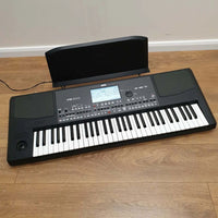 Angled top view of Korg Pa600 Professional Arranger on wooden surface