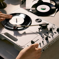 Angled view of Korg handytraxx play being used while on top of concrete surface