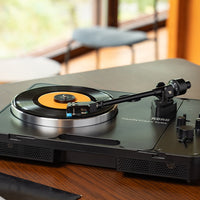 Angled front view of Korg handytraxx tube on wooden surface in living room