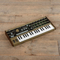 Angled view of Korg microKORG on wooden surface