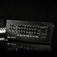 Angled front view of Korg minilogue xd module Polyphonic Analogue Synthesizer with another synthesizer behind it in black background
