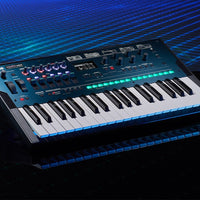 Angled front view of Korg opsix mk II on black surface with blue background
