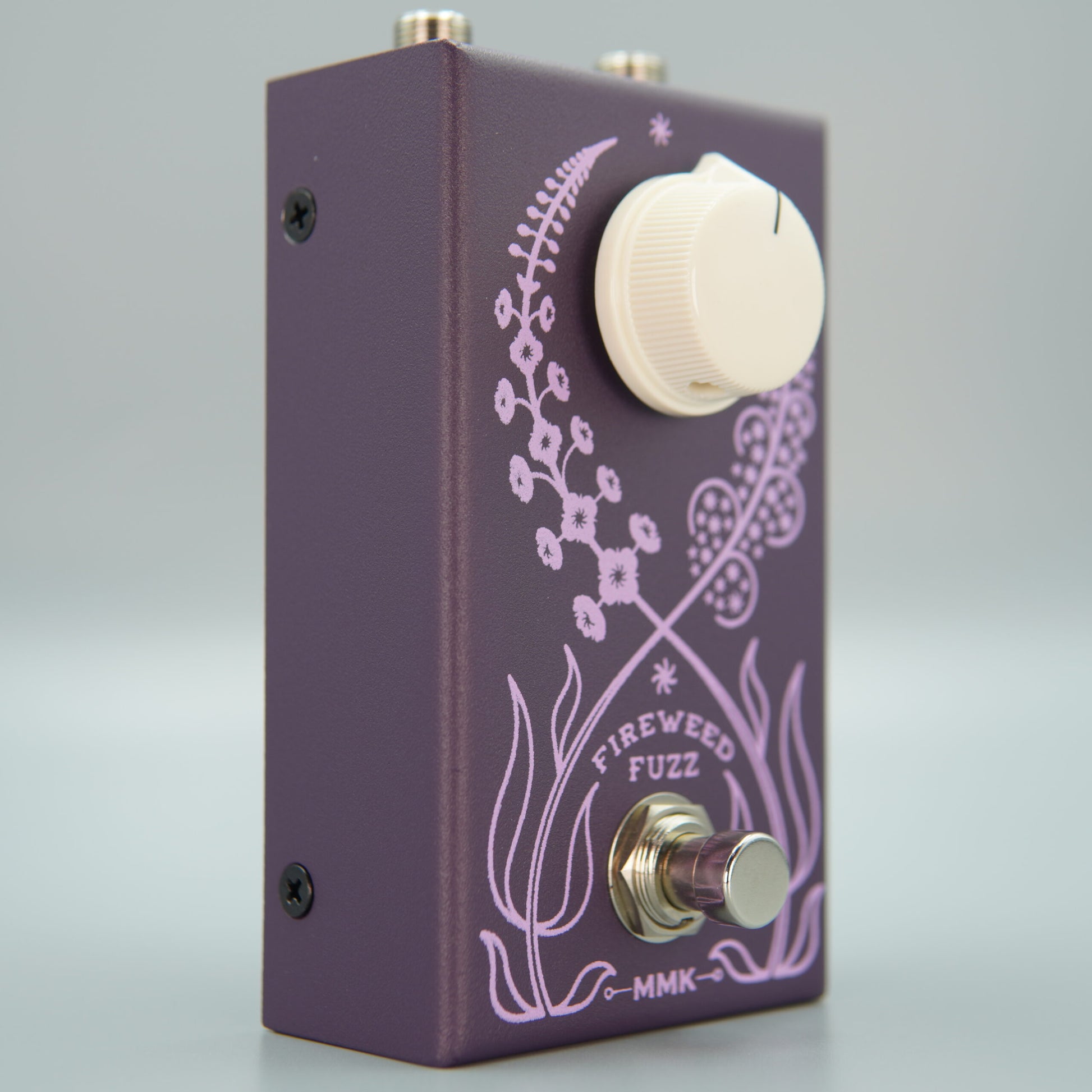 Angled front view of MMK Electrics Fireweed Fuzz Pedal on grey background