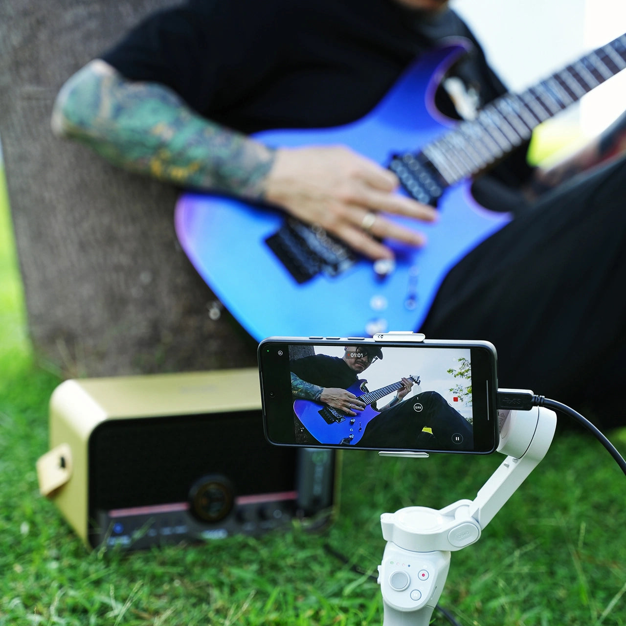 Guitarist playing through MOOER F15i Li Gold while recording himself outdoors