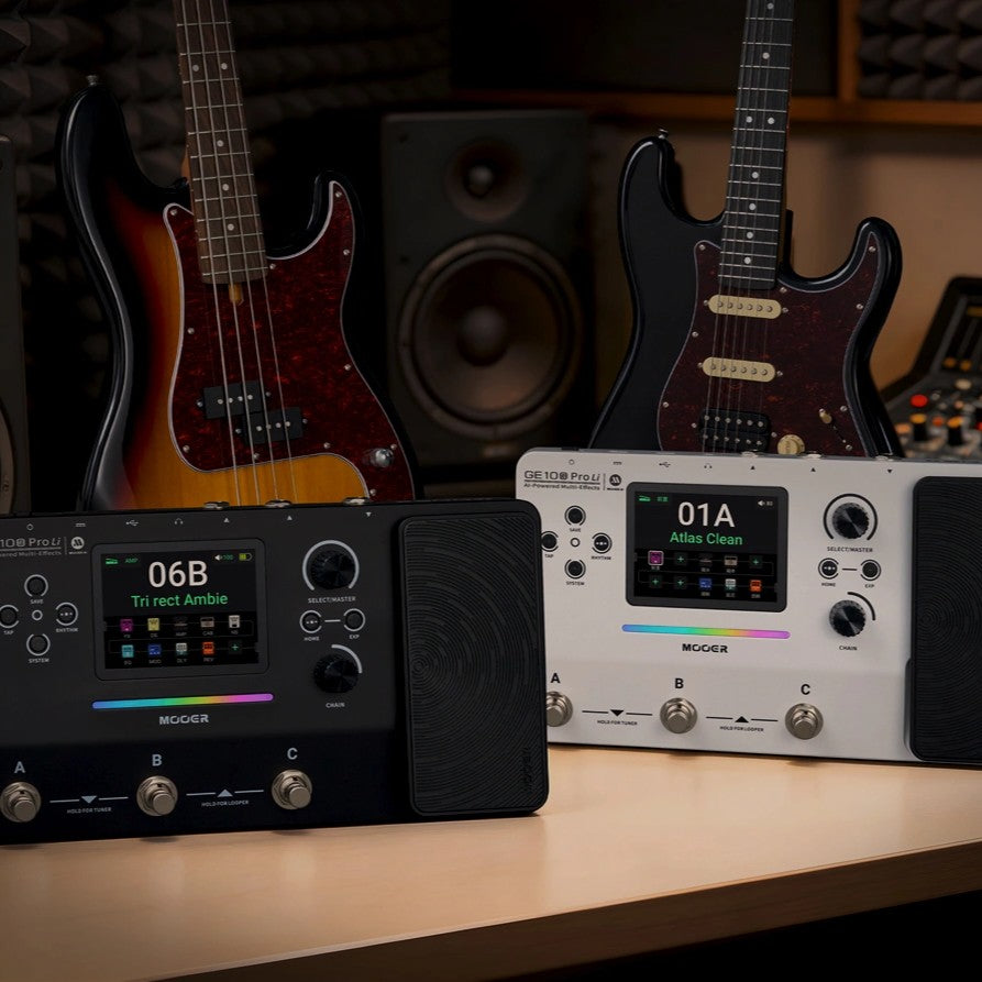 Front view of MOOER GE100 Pro Pedal and MOOER GE100 Pro Li Pedal side by side with bass and electric guitar behind it in studio