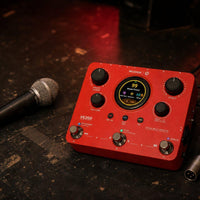 Angled front view of MOOER VE200 Vocal Multi Effects Pedal with microphone beside it on stage
