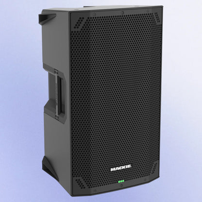 Angled view of Mackie Thump12v4 12” Professional Powered Loudspeaker on purple background