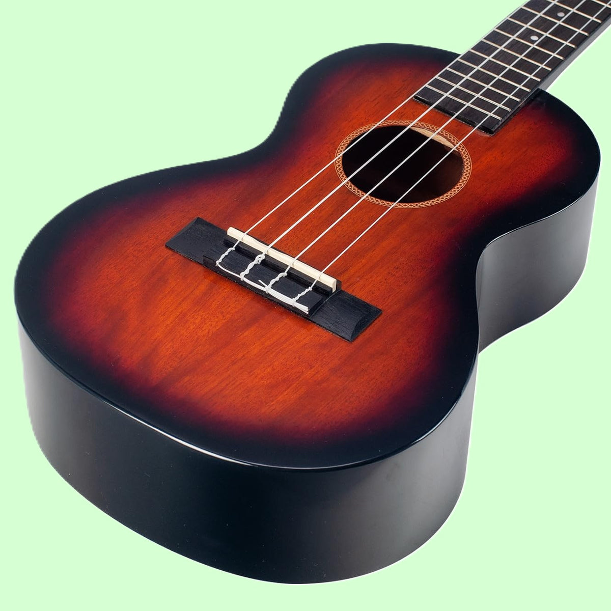 Close up angled view of Mahalo MJ3 Java Series Tenor Ukulele 3 Tone Sunburst on green background