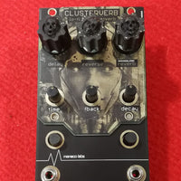 Close up front view of Maneco Labs Clusterverb Module Knobs on red background
