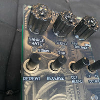 Close up view of Maneco Labs Cuatro A De 4AD Module on black couch