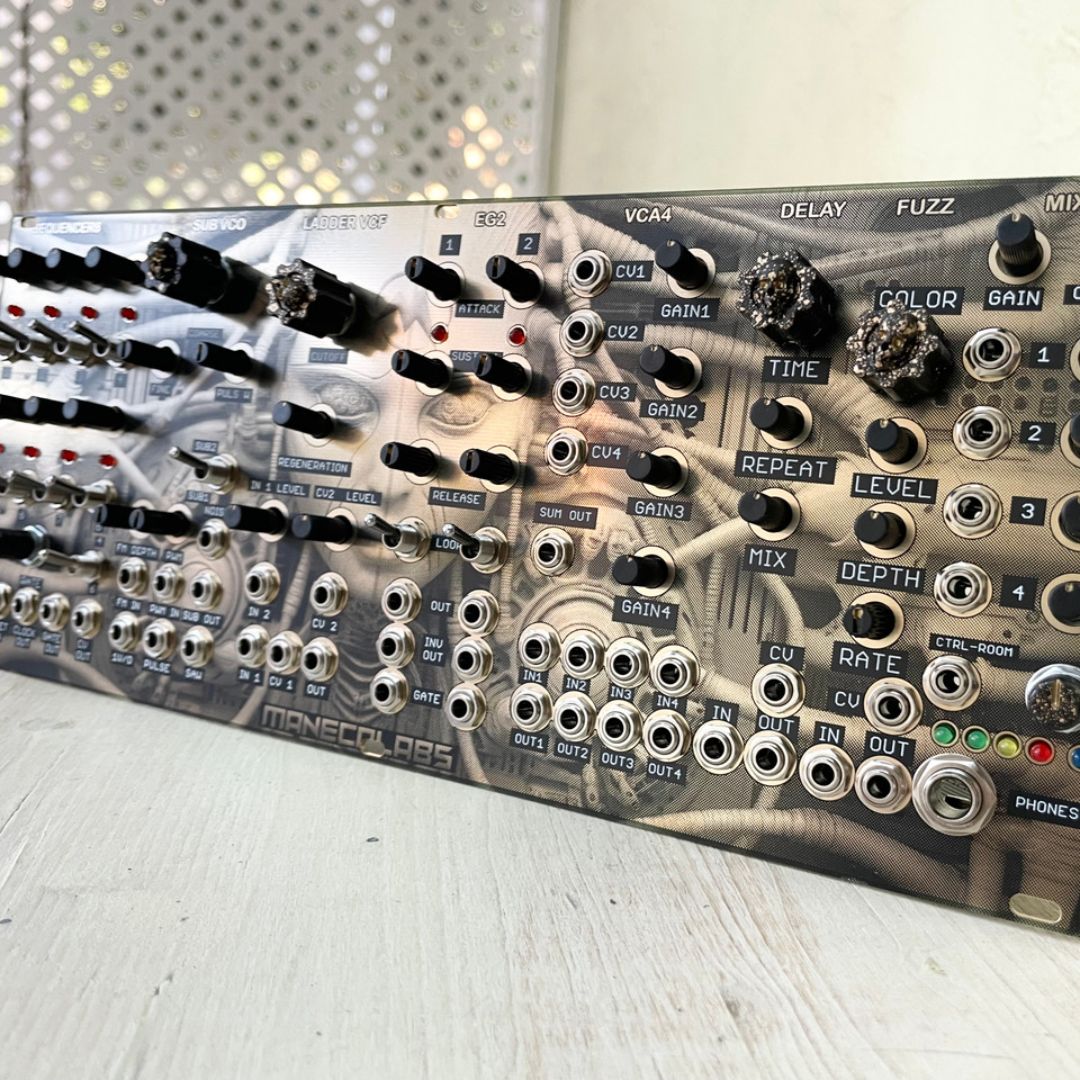 Angled front view of Maneco Labs Dark System M1 Module on wooden surface