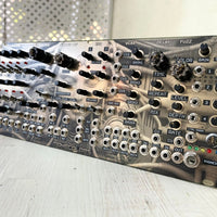 Angled front view of Maneco Labs Dark System M1 Module on wooden surface