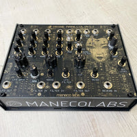Angled front view of Maneco Labs Manecolin Table Top Synth on wooden surface