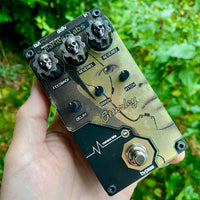 Maneco Labs Otterley Reverb Pedal Held Over a Nature Background