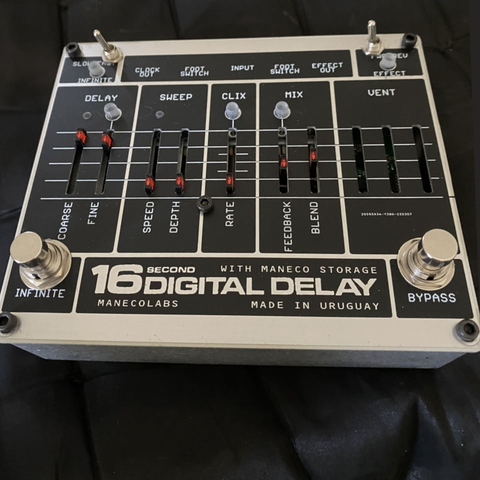 Maneco Labs Sixteen Second Delay Reissue Silver Pedal on a couch