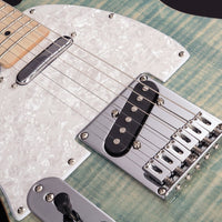 Close-up of a guitar's bridge and pickups on a textured surface