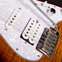 Close-up of a guitar's bridge and pickups with a white pickguard.