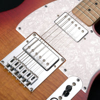 Close-up of a guitar's bridge and pickups with a white pickguard.