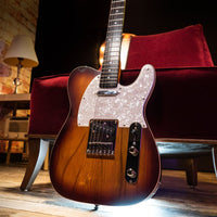 Electric guitar on a red couch with a warm ambiance