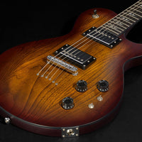 Close-up of a wooden electric guitar on a black background
