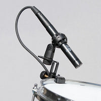Milab Microphone clamped on snare drum with grey background