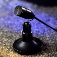 Close up shot of single Milab VM-44 Link MP on granite surface with blue-lit background