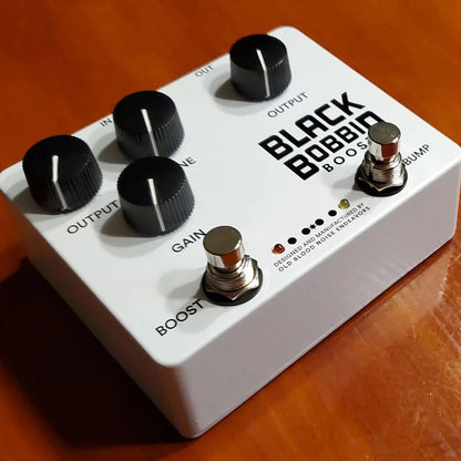 OBNE Black Bobbin Boost Pedal On a Wooden Surface