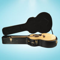 Side view of On-Stage Hardshell Jumbo Acoustic Guitar Case with lid open and acoustic guitar inside on blue background