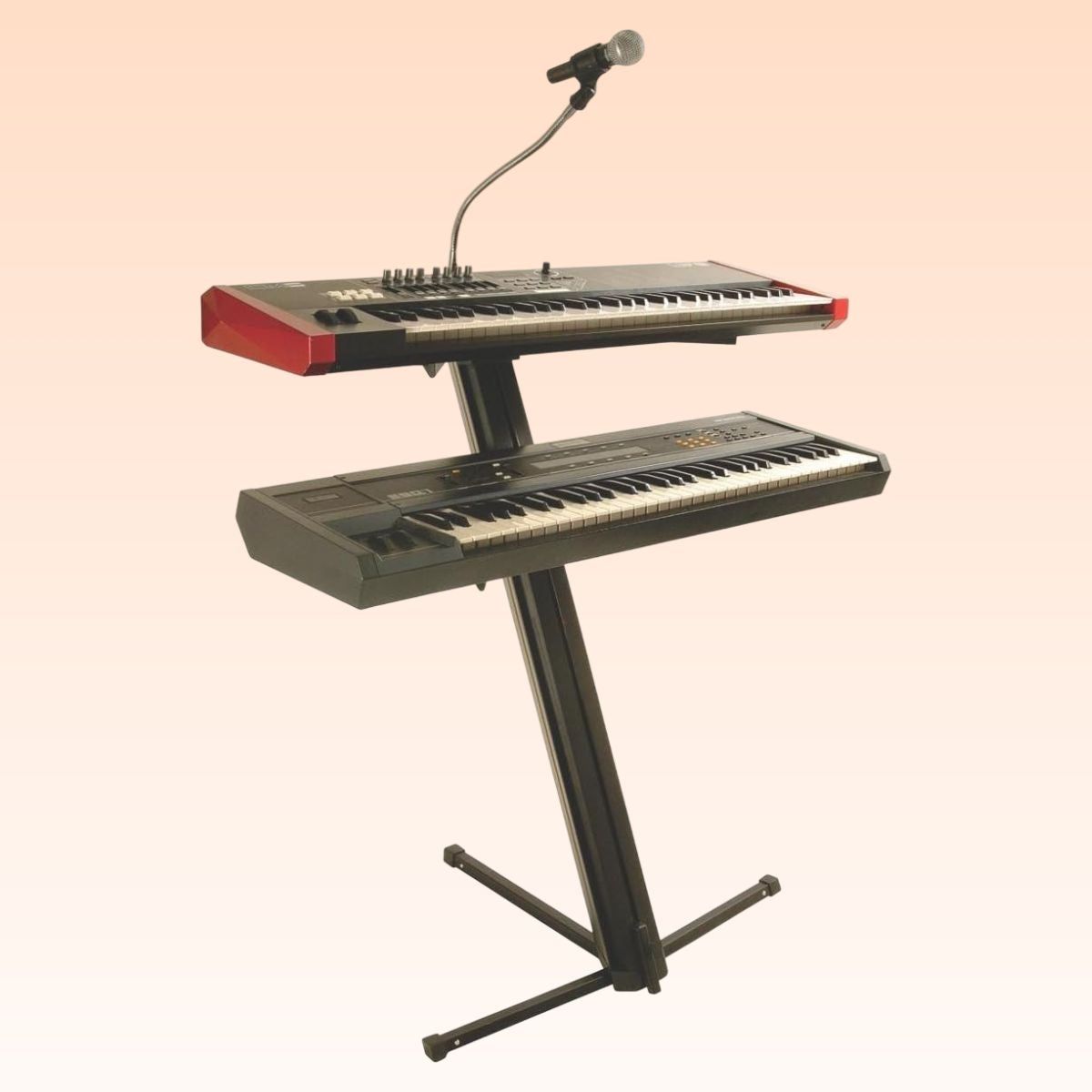 Angled view of On-Stage Quantum Core Column Keyboard Stand with keyboards and mic mounted on orange background