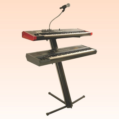 Angled view of On-Stage Quantum Core Column Keyboard Stand with keyboards and mic mounted on orange background