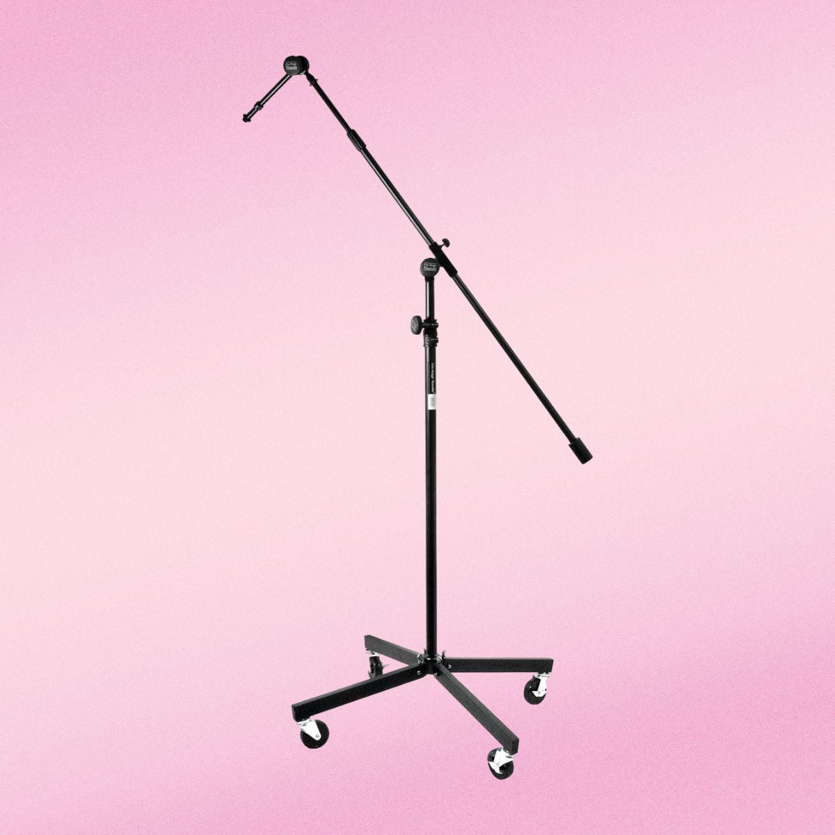 Front view of On-Stage Tripod Studio Mic Boom w/ 7" Mini Boom Extension & Casters on pink background